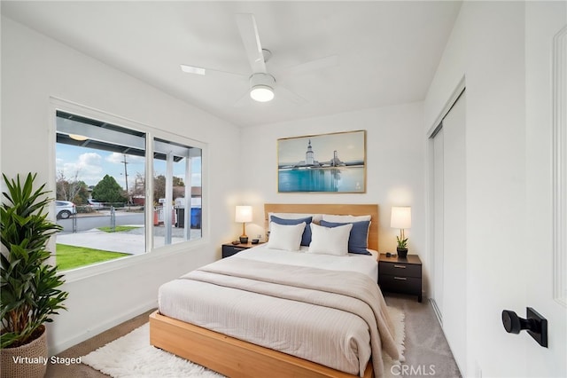 bedroom with ceiling fan, a closet, and carpet floors