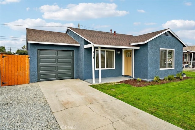 ranch-style home featuring a garage and a front lawn