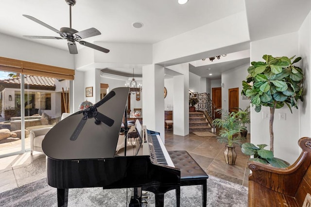 miscellaneous room featuring ceiling fan with notable chandelier