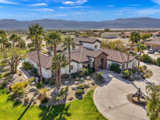 birds eye view of property with a mountain view