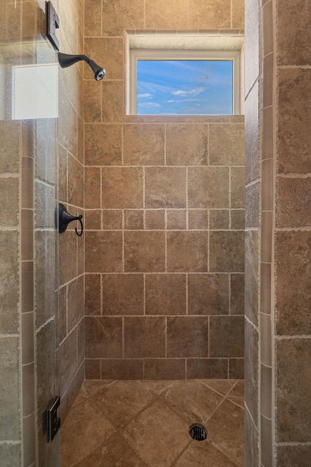 bathroom with a tile shower