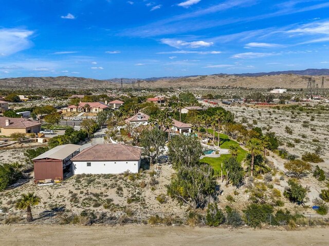 birds eye view of property with a mountain view