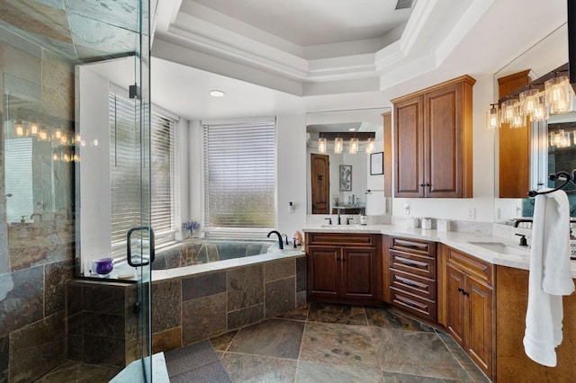 bathroom featuring vanity, a raised ceiling, and shower with separate bathtub