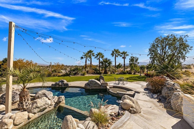 view of pool with a yard