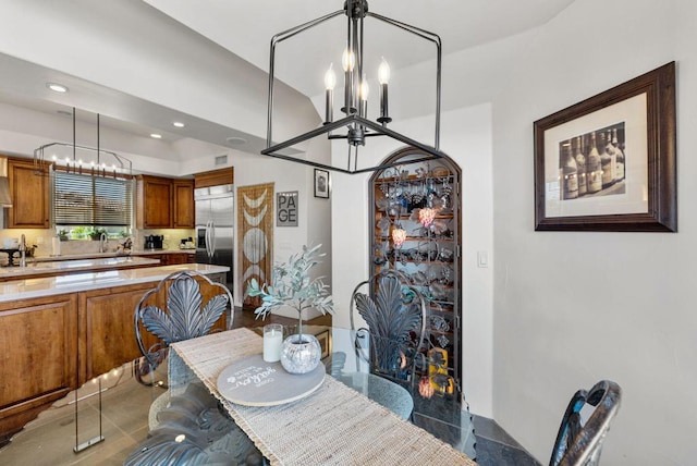 dining room featuring sink and an inviting chandelier