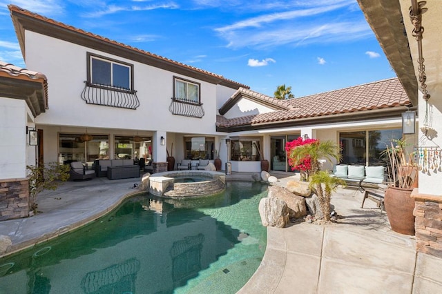 rear view of house featuring an outdoor living space, a swimming pool with hot tub, and a patio