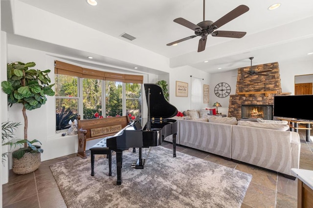 living room featuring ceiling fan and a fireplace