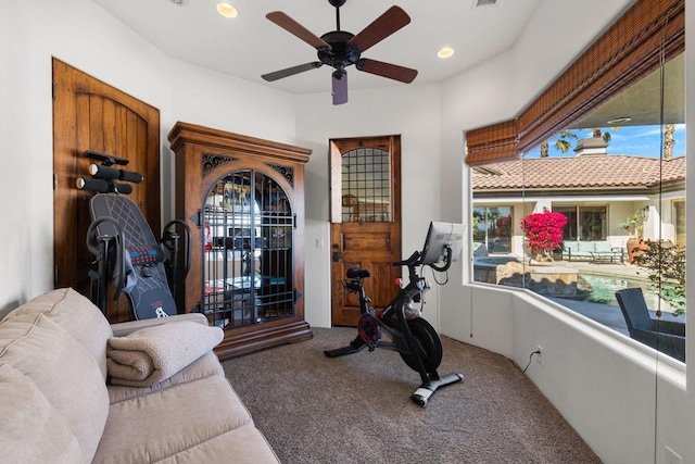 workout area with carpet and ceiling fan