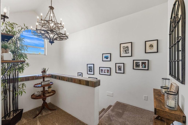 bar with lofted ceiling, pendant lighting, carpet flooring, butcher block counters, and a chandelier