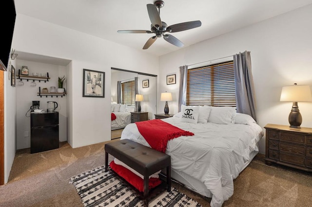 carpeted bedroom featuring ceiling fan and a closet