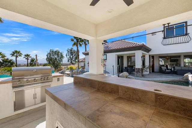 view of patio / terrace featuring exterior kitchen, ceiling fan, and area for grilling