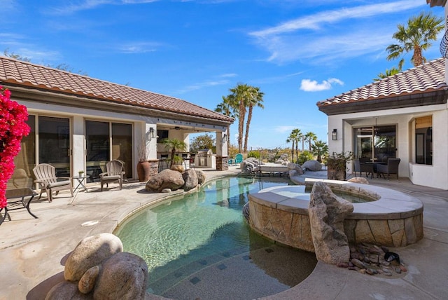 view of swimming pool featuring an in ground hot tub and a patio