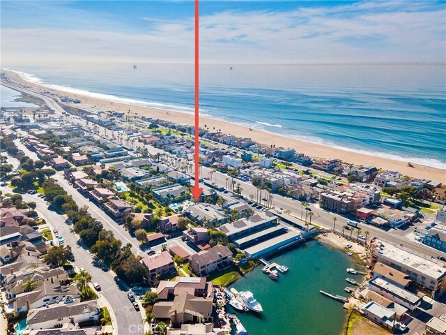 bird's eye view featuring a water view and a beach view