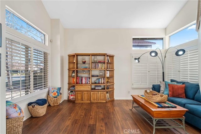 sitting room with dark wood-type flooring