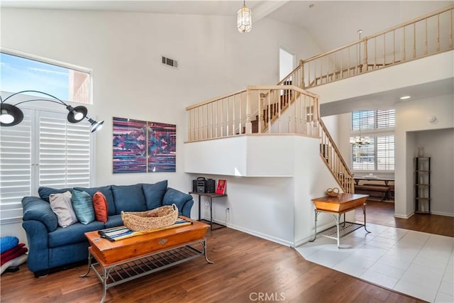 living room featuring hardwood / wood-style flooring, plenty of natural light, and high vaulted ceiling