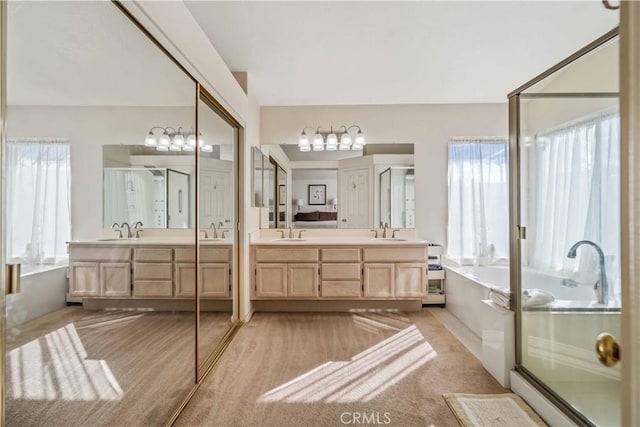 bathroom with separate shower and tub and vanity