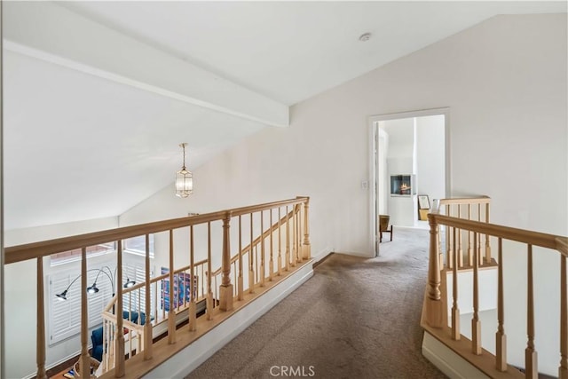 hallway featuring carpet and vaulted ceiling