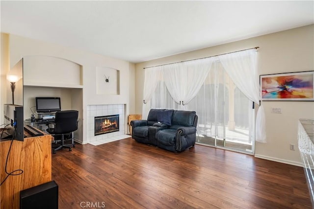 living room featuring dark hardwood / wood-style flooring and a fireplace