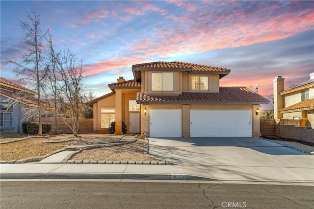 mediterranean / spanish-style home with a garage