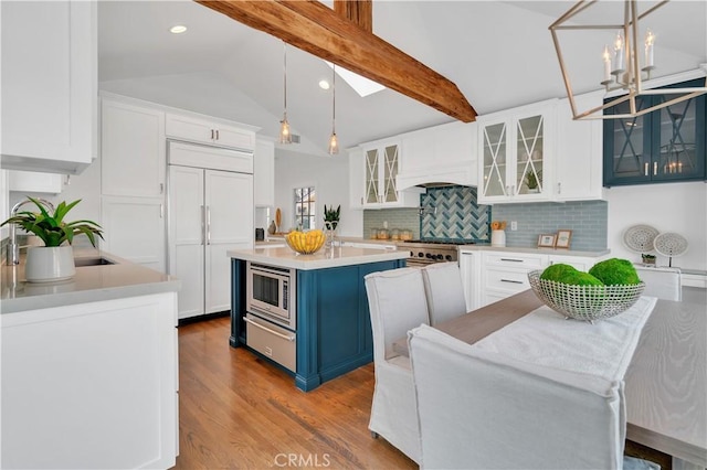 kitchen with white cabinets, hanging light fixtures, and a center island