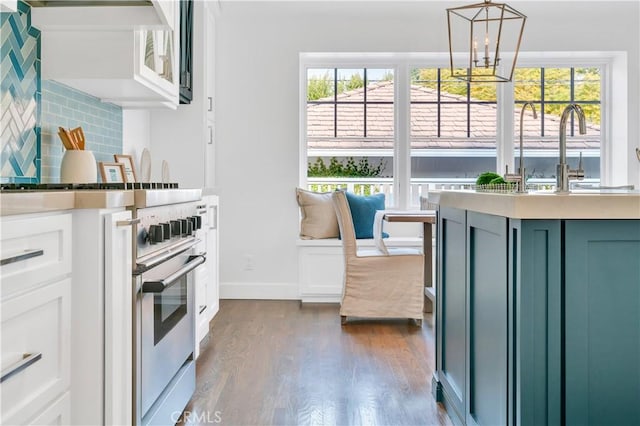 kitchen featuring decorative light fixtures, dark hardwood / wood-style floors, plenty of natural light, and an inviting chandelier