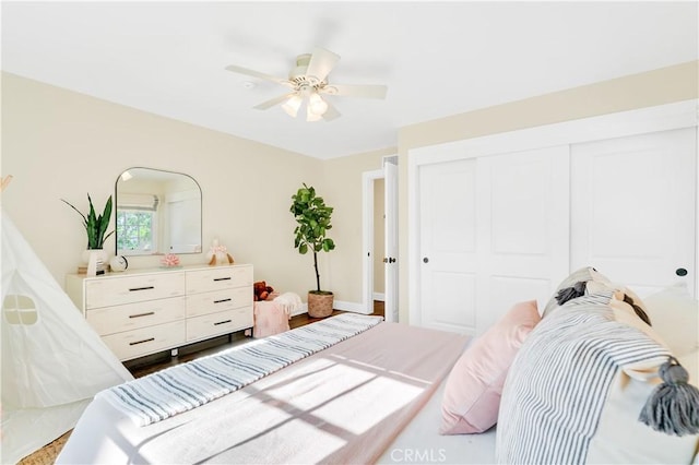 bedroom featuring ceiling fan and a closet