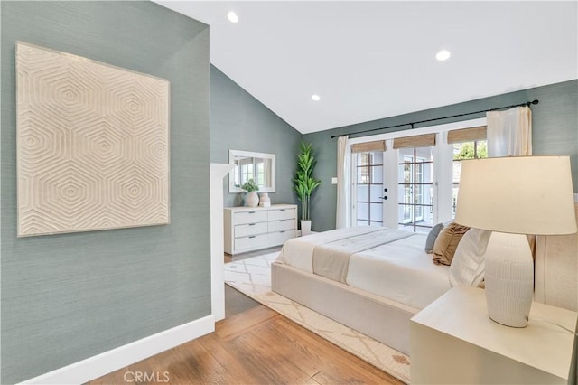 bedroom with access to exterior, wood-type flooring, french doors, and vaulted ceiling