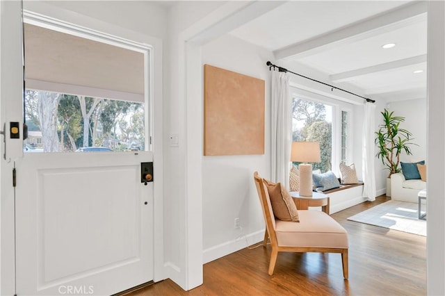 entryway with beam ceiling and hardwood / wood-style floors