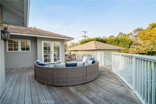 wooden deck with outdoor lounge area and french doors