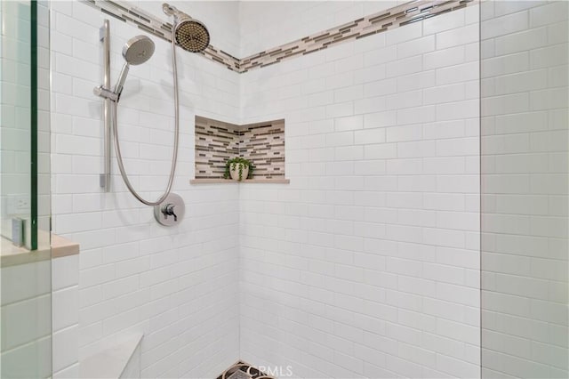 bathroom with tiled shower