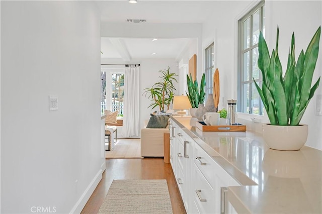 interior space featuring hardwood / wood-style floors and beam ceiling