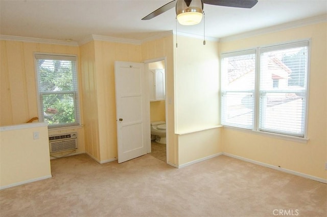 unfurnished bedroom with crown molding, light colored carpet, and a wall unit AC