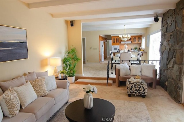 living room with an inviting chandelier, light colored carpet, and beamed ceiling