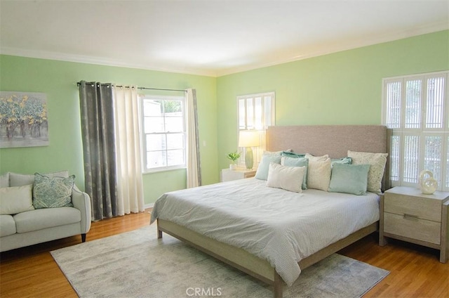 bedroom featuring hardwood / wood-style flooring and ornamental molding