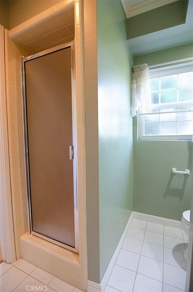 bathroom with toilet, tile patterned floors, and a shower with shower door