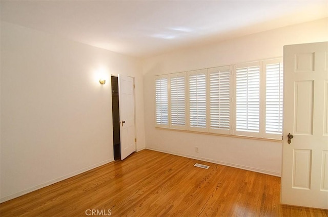 unfurnished room featuring light hardwood / wood-style flooring