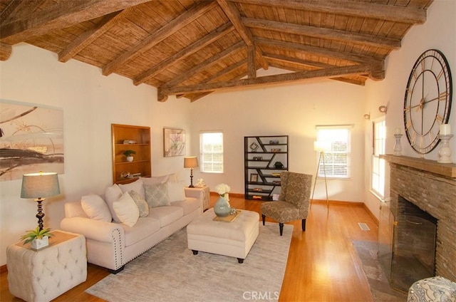 living room with beamed ceiling and wooden ceiling