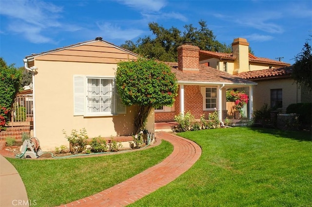 mediterranean / spanish-style house featuring a front yard