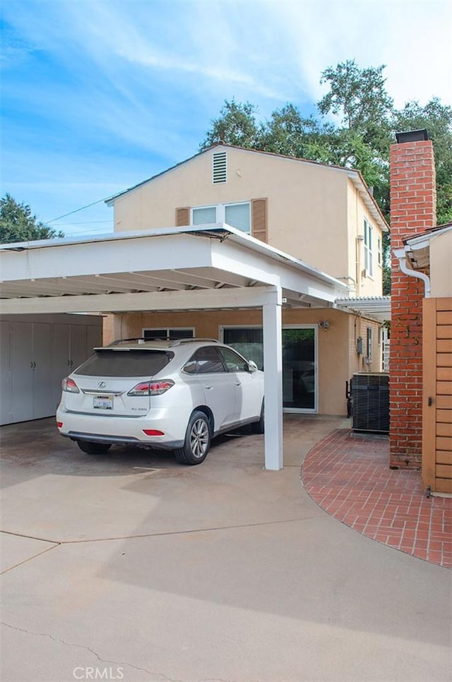 view of parking / parking lot featuring a carport