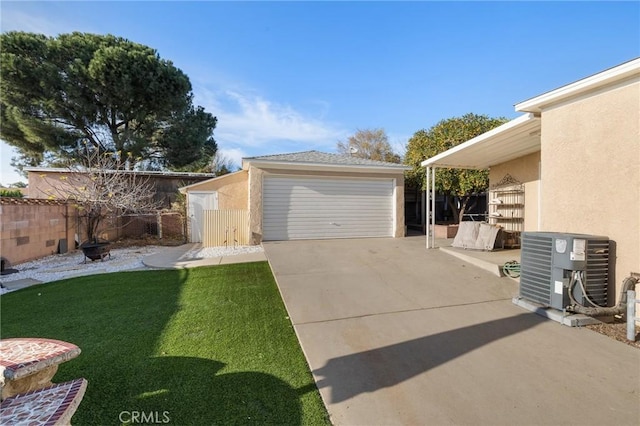 view of side of home featuring a garage, a yard, an outdoor structure, and central AC