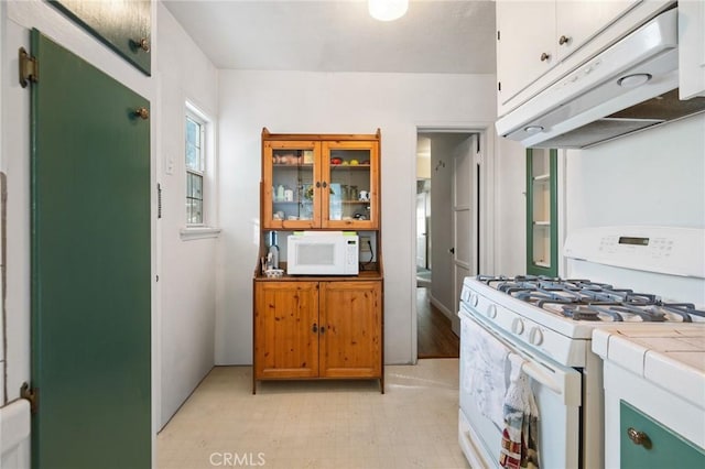 kitchen featuring tile counters and white appliances