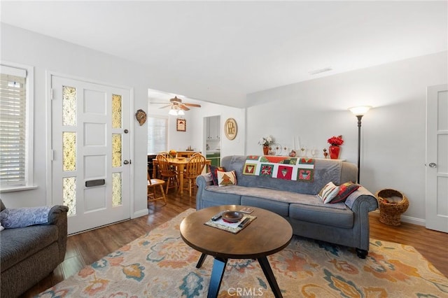 living room featuring ceiling fan and hardwood / wood-style flooring