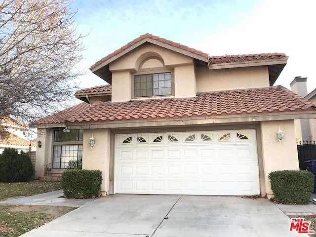 mediterranean / spanish-style home featuring a garage