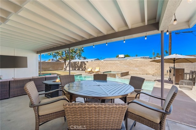 view of patio / terrace featuring a pool with hot tub and an outdoor fire pit