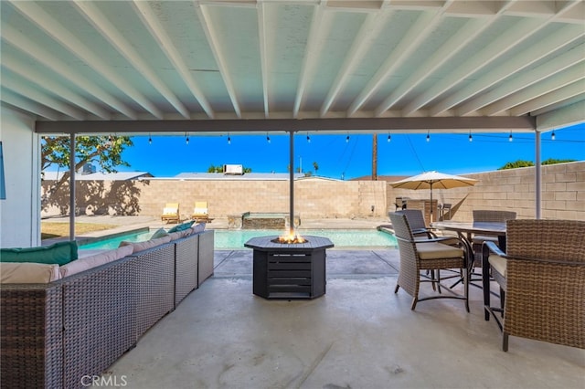 view of patio / terrace with an outdoor living space with a fire pit