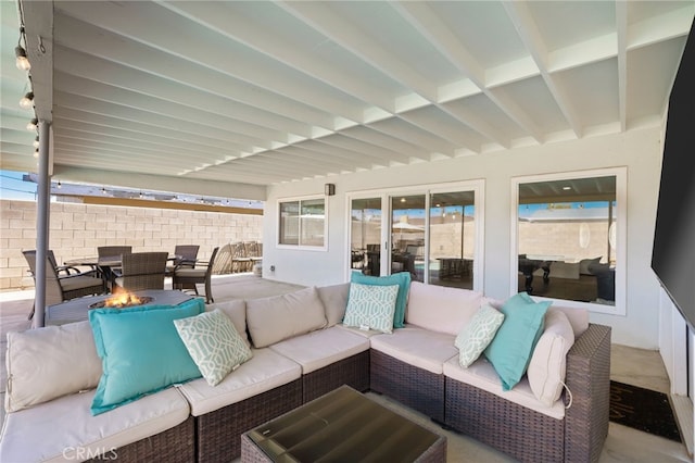 view of patio featuring an outdoor living space with a fire pit