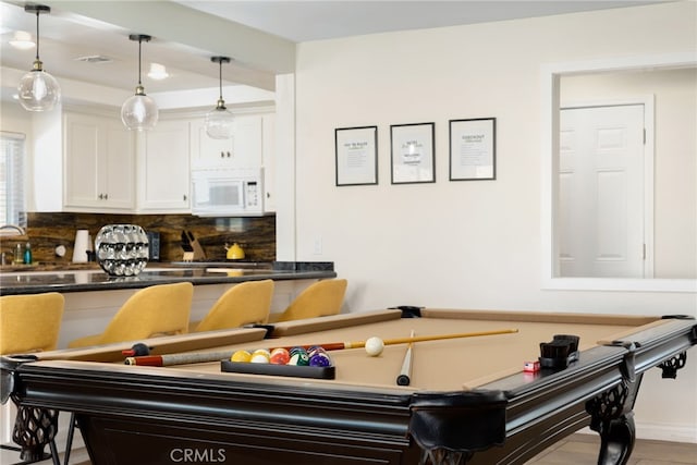 game room with pool table and light hardwood / wood-style floors