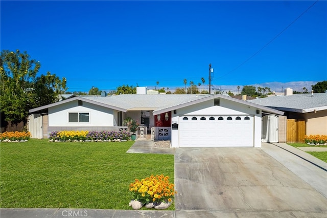 ranch-style house featuring a front lawn and a garage