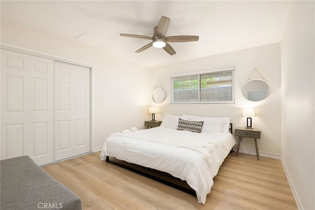 bedroom with ceiling fan, a closet, and light hardwood / wood-style flooring