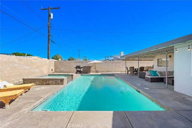 view of swimming pool featuring an outdoor living space, an in ground hot tub, and a patio